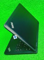 Lenovo Yoga 11e partially closed laptop with logo visible