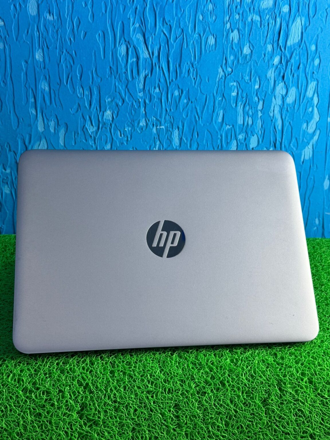 Closed HP 725 G4 laptop with HP logo on the lid